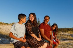 Family sitting together on the beach